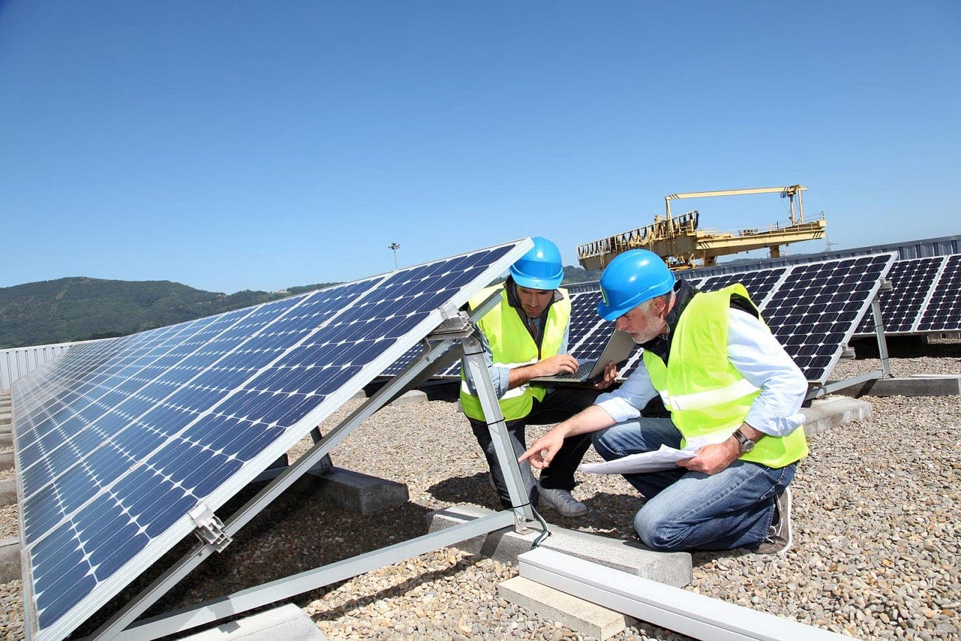 Technician cleaning and maintaining solar panels