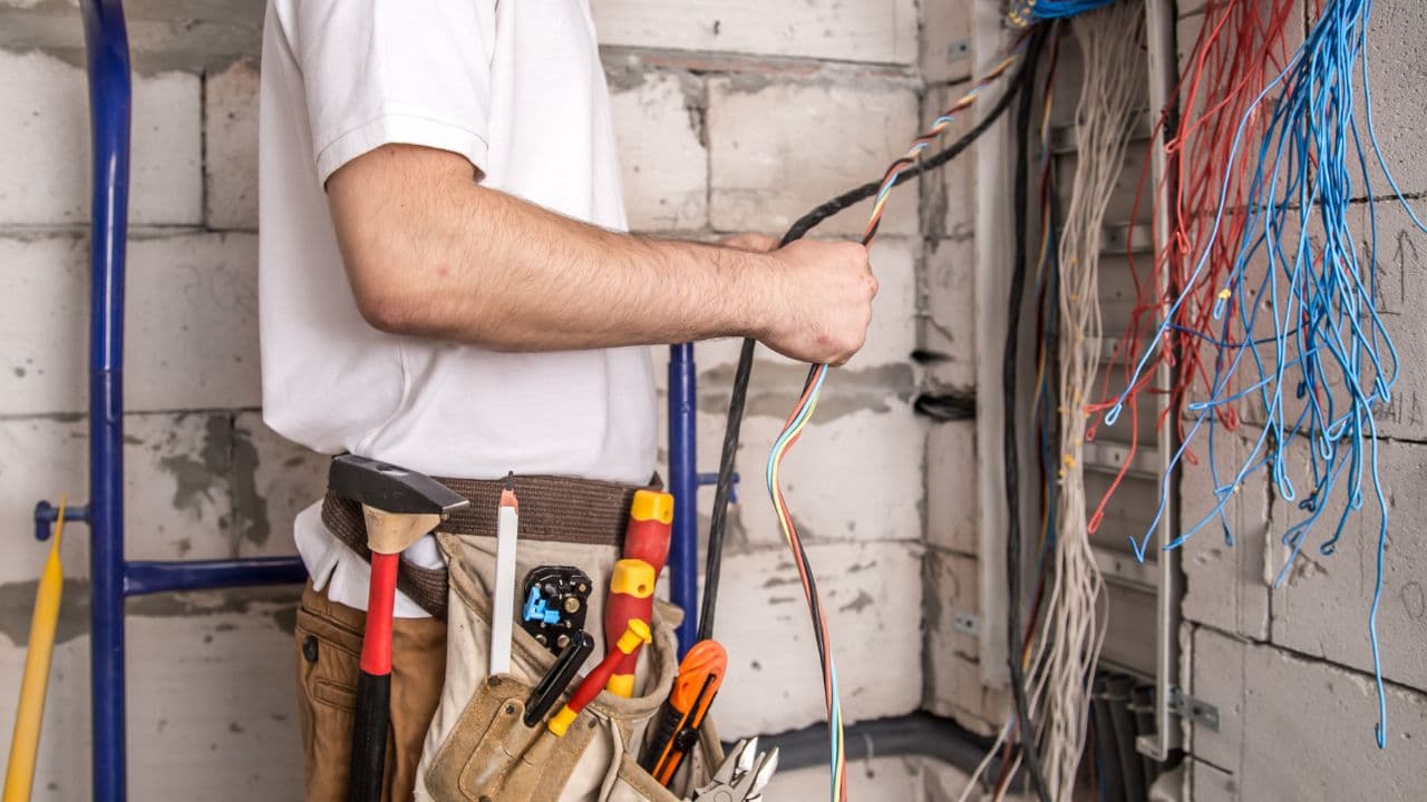 Electricians installing wiring in new building